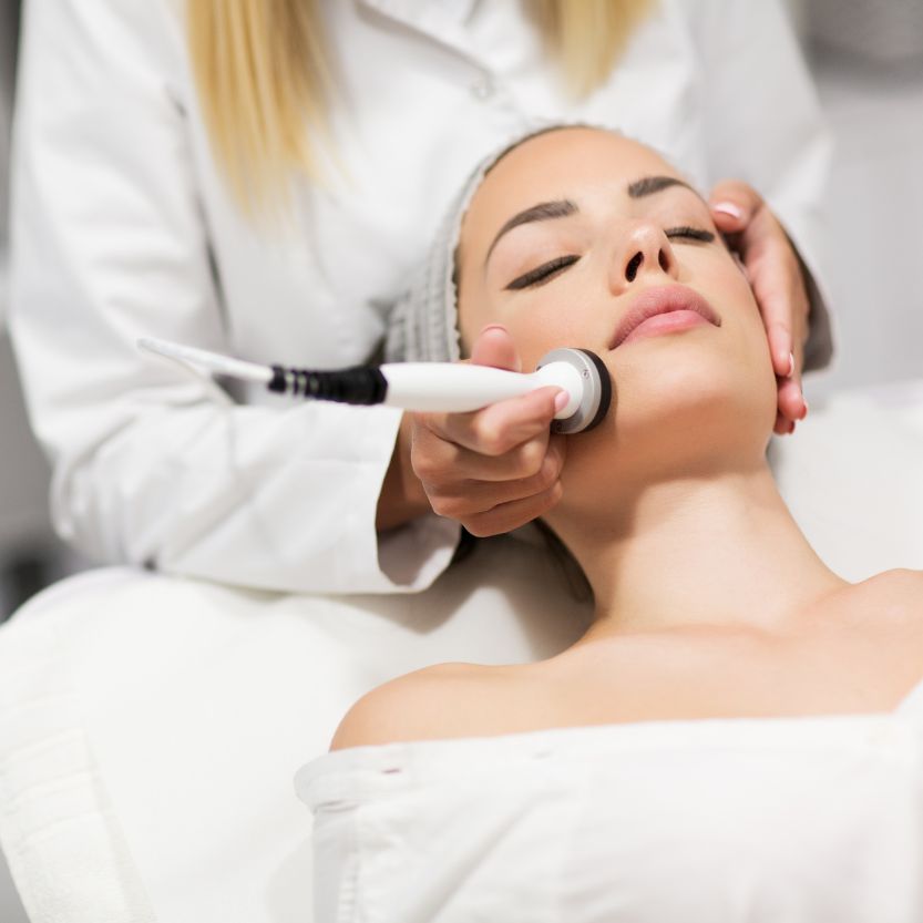 Woman receiving facial treatment