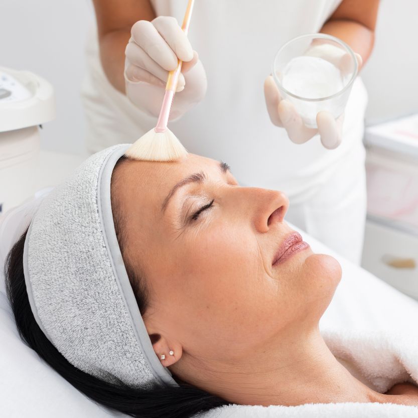 Woman receiving facial treatment