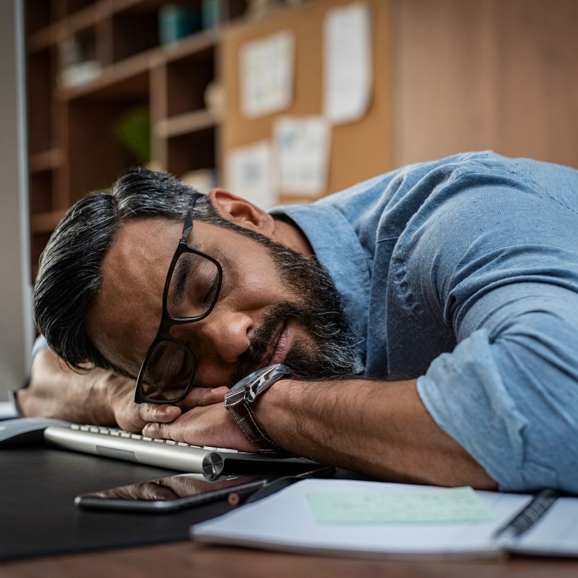 Fatigued man sleeping on desk